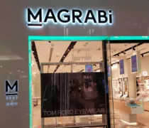 Storefront of Magrabi, featuring illuminated signage and a display of Tom Ford eyewear in a modern retail environment